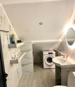 a bathroom with a washing machine and a sink at Coastal vista retreat in Neos Panteleimonas