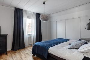 a bedroom with a large bed and a window at Amazing family home in Stockholm in Stockholm