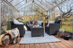 a gazebo with chairs and a table in it at Amazing family home in Stockholm in Stockholm