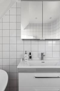 a white bathroom with a sink and a toilet at Amazing family home in Stockholm in Stockholm