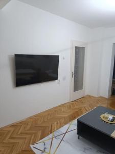 a living room with a flat screen tv on a wall at Big Apartment Veles in Veles