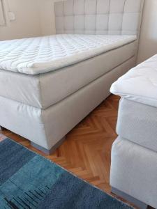 a mattress sitting on a floor next to a couch at Big Apartment Veles in Veles