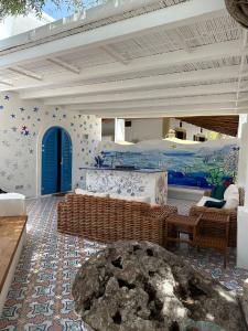 a living room with a bed and a couch at Art B&B in Panarea
