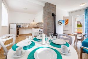 a dining room and kitchen with a table and chairs at Morska Kraina in Białogóra