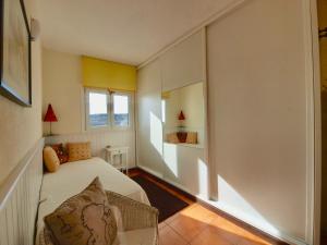 a small bedroom with a bed and a window at sunrise directly at the sea in La Mareta