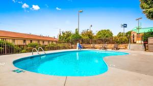 a swimming pool with blue water in a parking lot at Best Western Statesville Inn in Statesville