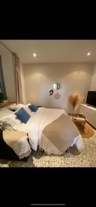 1 dormitorio con 2 camas con sábanas blancas y almohadas azules en Appartement en bord de mer, en Fos-sur-Mer