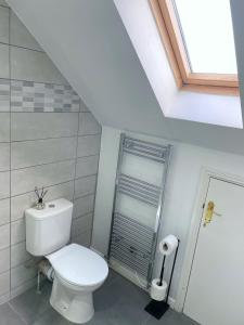 a white bathroom with a toilet and a shower at Mayflower House Barnsley-Wombwell-3 Bedrooms-2 Showers-Longer Stay- Free Parking in Barnsley
