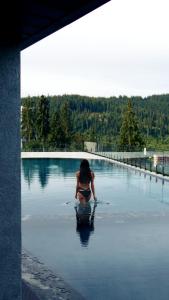 een vrouw die in het water zit in een lichaam van water bij Hotel Podgorie Spa in Boekovel
