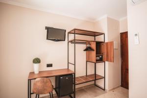 a room with a desk and a tv on a wall at Hotel Xunqueira in Portonovo