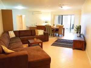 a living room filled with furniture and a couch at Edge Apartments Cairns in Cairns