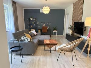 a living room with a couch and a table at Summer Green Apartment in Nedeščina
