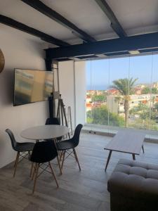 a room with a table and chairs and a large window at Eurosol in Torremolinos