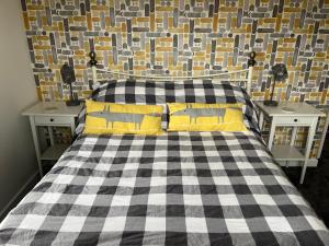 a bedroom with a black and white checkered bed at Lovely 3 bed house near Anfield Stadium with private parking and garden Guests must be 25 years or over to make a booking in Liverpool