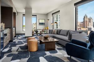 a living room with a couch and a table at The Trade, Autograph Collection in Milwaukee