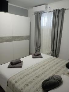 a bedroom with a bed with two pillows on it at Pia Apartment in Dugi Rat