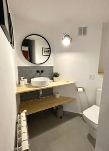 a bathroom with a sink and a mirror at Tuca - Triplex Priviletge con encanto in Vielha