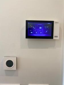 a flat screen tv on a wall with a speaker at Lustica Bay Centrale Sparcle in Tivat