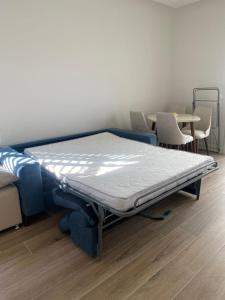 a bed in a room with a table and chairs at Lustica Bay Centrale Sparcle in Tivat