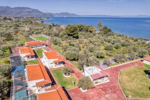 an aerial view of a house with the water at Blue Marine Village in Chalkida