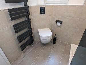 a bathroom with a white toilet in a room at Ferienwohnung Rheinperle in Niederheimbach +13 photos