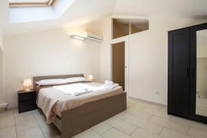 a bedroom with a large bed in a room at Royal Playa Suite and Apartament -private parking- self chek out in Catania