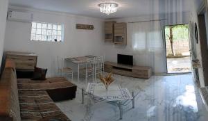 a living room with a couch and a table at Anchorage Apartment in Rachoni in Rachonio