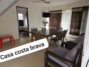 a living room with a dining room table and chairs at Casa Costa Brava in Acapulco