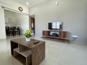 a living room with a tv and a coffee table at SSN Home Stays in Bangalore near PLAY Arena in Bengaluru