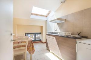 a kitchen with a sink and a counter top at Royal Playa Suite and Apartament -private parking- self chek out in Catania +37 photos