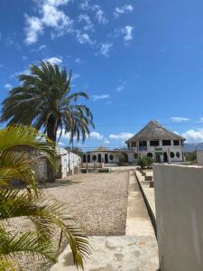 a house with a palm tree in front of it at Casa Maya Playa El Yaque in El Yaque
