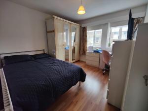 a bedroom with a bed and a desk and window at Beautiful and homely accommodation, Archway in Islington near Camden town in London