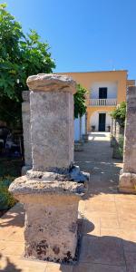 a stone pillar in front of a building at Villa PARADISO - Tra Ulivi e Tramonti da Cartolina in Muro Leccese