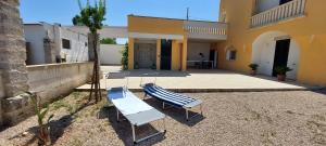 a group of chairs sitting outside of a house at Villa PARADISO - Tra Ulivi e Tramonti da Cartolina in Muro Leccese