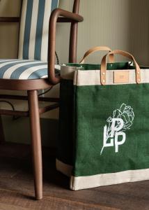 a green bag sitting next to a chair at Le Petit Pali at Ocean Ave in Carmel
