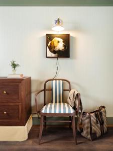 a chair in a room with a picture of a dog at Le Petit Pali at Ocean Ave in Carmel