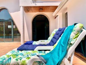 a couple of chairs sitting on a porch at Villa a 300 metros de playa Francón in Cangas de Morrazo