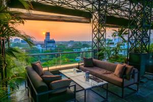 a living room with a couch and a table at O Hotel Pune in Pune