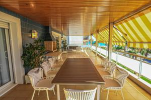 a cafeteria with tables and chairs on a balcony at LITORAL COSTA DORADA - AQUARIUM Only families in Cambrils