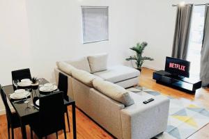 a living room with a couch and a table at 2 Bed Apartment with Free Parking in Chelmsford