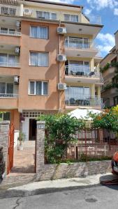 a building with balconies and a fence in front of it at Guest House Diamandievi in Nesebar