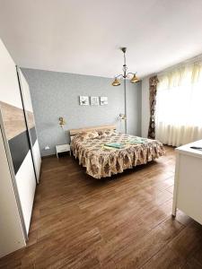 a bedroom with a bed and a wooden floor at Apartament lux Albert in Olimp