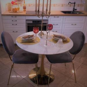 a table in a kitchen with two glasses of wine at Historic house residence in Vilnius