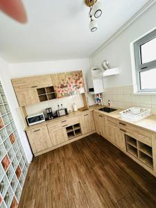 a kitchen with wooden cabinets and a sink and a window at Apartament lux Albert in Olimp