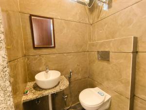 Hotel Veer Palace near Udaipole Udaipur في أودايبور: حمام مع حوض ومرحاض