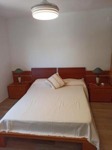 a bedroom with a large bed with two night stands at APARTAMENTO 1ª LÍNEA EN PLAYA DE GANDÍA in Playa de Gandia