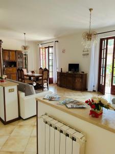 a large kitchen and living room with a table at La casa del Tiglio in Sarzana