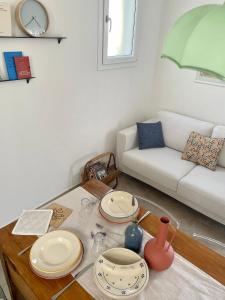 a living room with a table and a couch at Itaca in Castro di Lecce