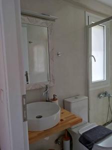 a bathroom with a sink and a toilet and a mirror at Elafonisos Loft B3 in Elafonisos