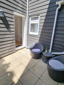 a patio with a toilet sitting next to a building at The Cottage @ St Margarets in Ryde